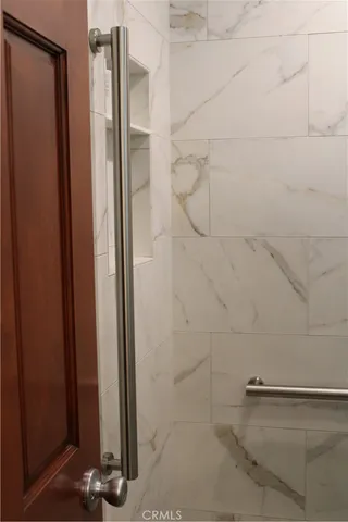 a bathroom with a sink a mirror and next to a window