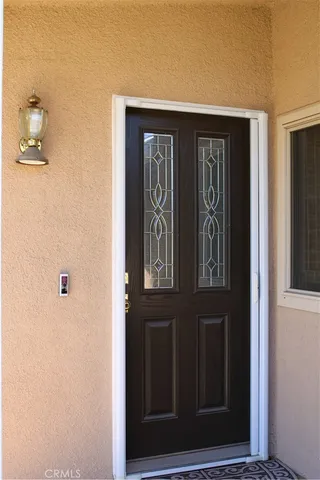 a view of an empty room with wooden floor and windows