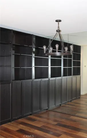 a view of a livingroom with wooden floor and staircase