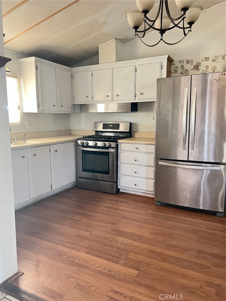 53670 Cave Rock Road Anza, CA 92539 - Photo 3 of 9 a kitchen with stainless steel appliances granite countertop a refrigerator a stove a sink and white cabinets
