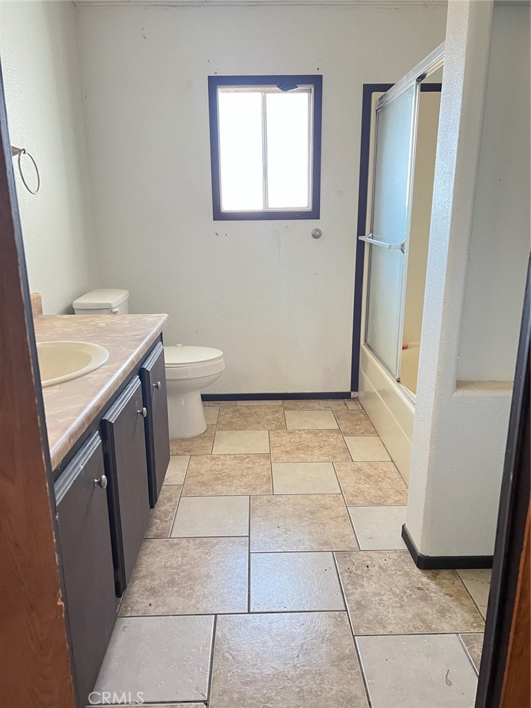 53670 Cave Rock Road Anza, CA 92539 - Photo 9 of 9 a bathroom with a granite countertop sink a toilet and a mirror