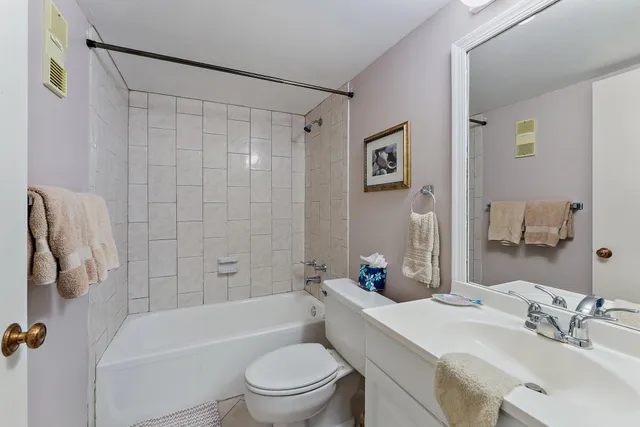 a bathroom with a sink a toilet a mirror a shower and a bathtub