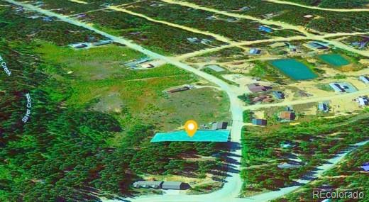 Lot 47 Silver Creek Road Idaho Springs, CO 80452 - Photo 7 of 7 a backyard of a house with lots of green space and mountain view in a back yard