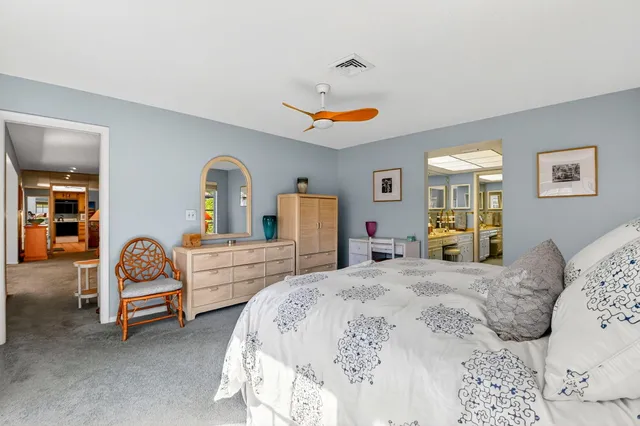 a bedroom with a bed and a large mirror