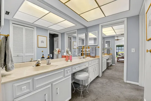 a large bathroom with a double vanity sink a mirror and a bathtub