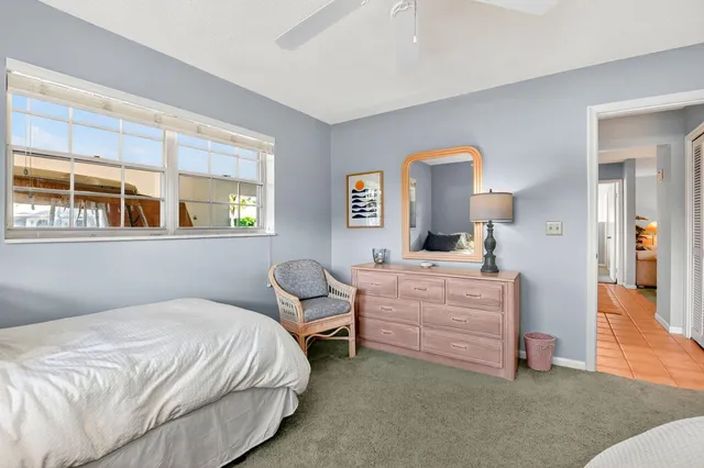 a bedroom with a bed and a mirror