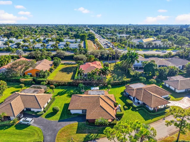 an aerial view of residential houses with outdoor space and swimming pool