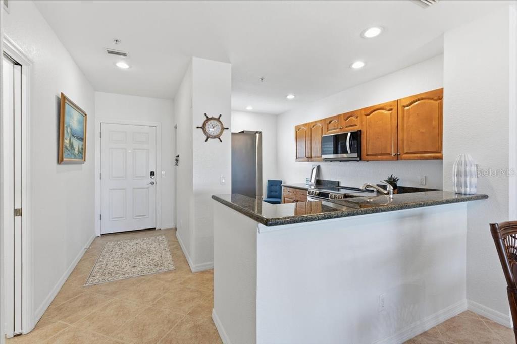 8411 Placida Road, Unit 407 Placida, FL 33946 - Photo 6 of 43 a kitchen with granite countertop a sink stove and refrigerator