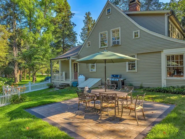 a view of a house with backyard sitting area and garden