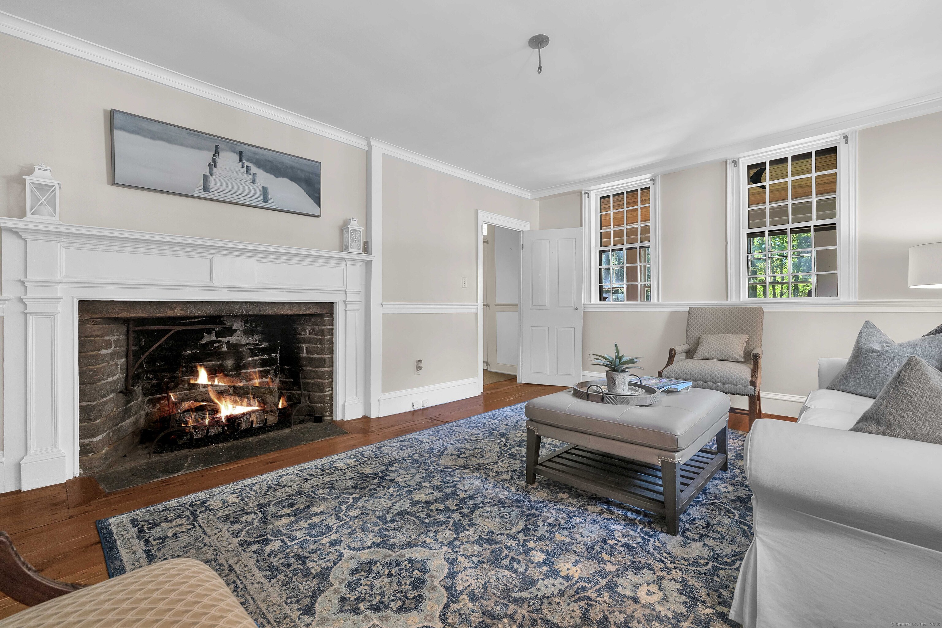448 Grove Beach Road North Westbrook, CT 06498 - Photo 22 of 40 a living room with furniture and a fireplace