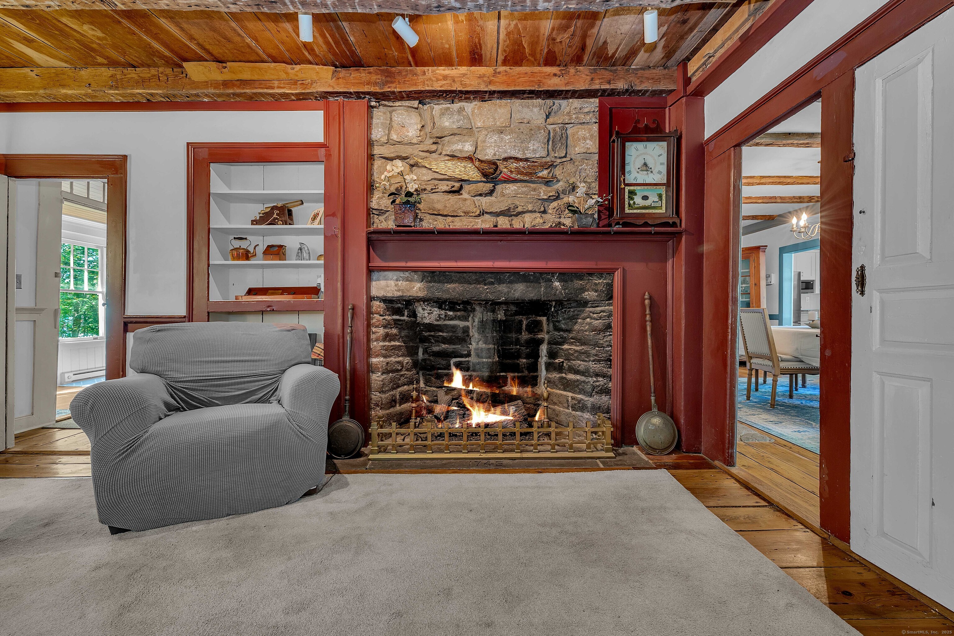 448 Grove Beach Road North Westbrook, CT 06498 - Photo 23 of 40 a living room with furniture and a fireplace