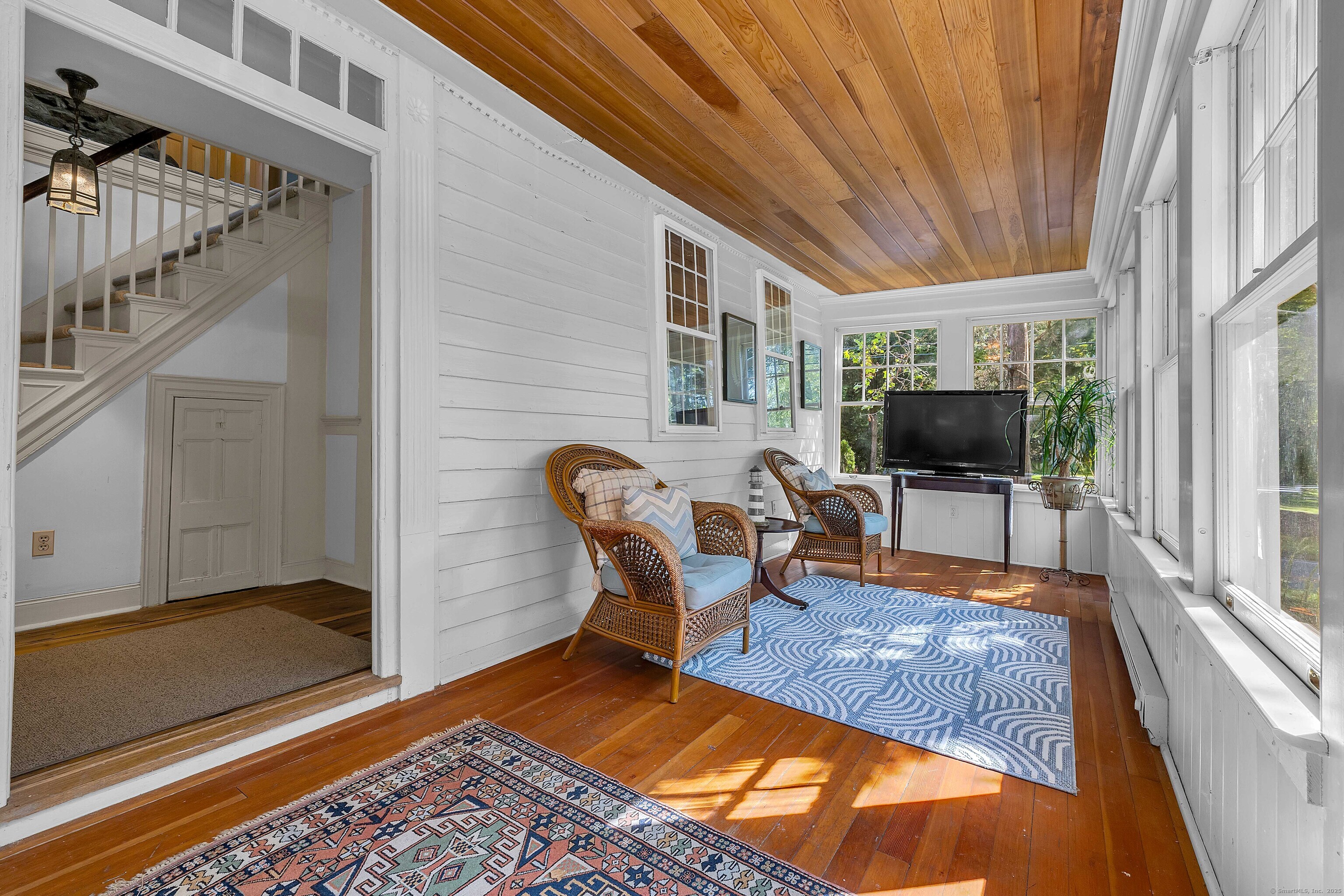 448 Grove Beach Road North Westbrook, CT 06498 - Photo 25 of 40 a living room with furniture a flat screen tv and a rug