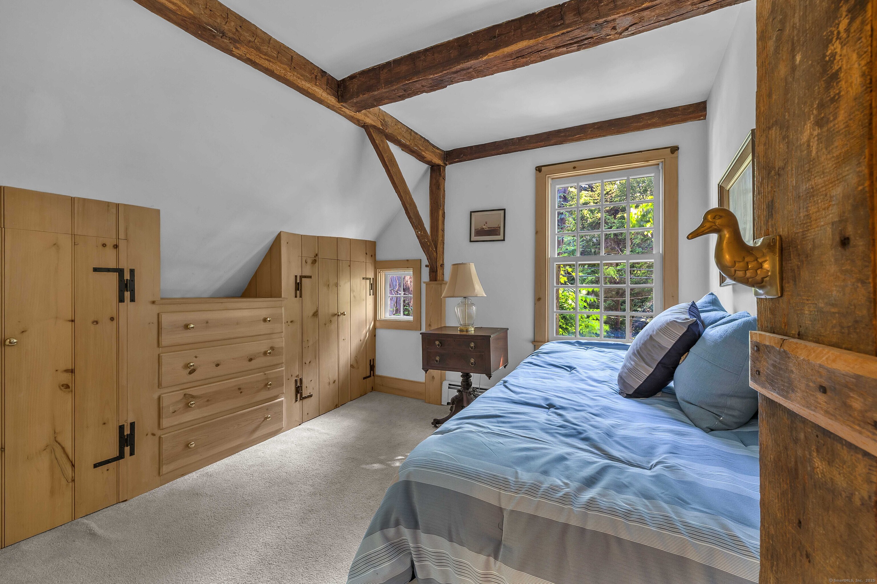 448 Grove Beach Road North Westbrook, CT 06498 - Photo 31 of 40 a bedroom with a bed and wooden floor