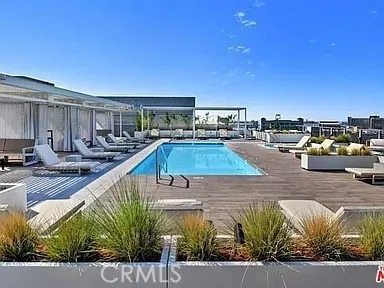 a view of a swimming pool with outdoor seating