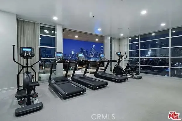 a room with gym equipment and a flat screen tv