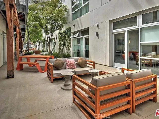 a outdoor space with a couch and a potted plant
