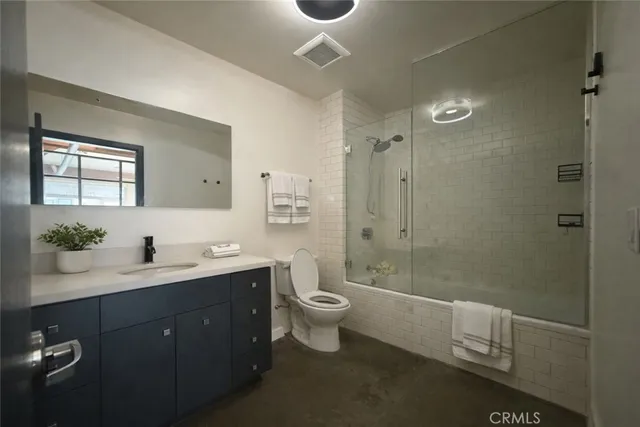 a spacious bathroom with a double vanity sink toilet and a shower