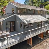 a view of a house with roof and wooden fence
