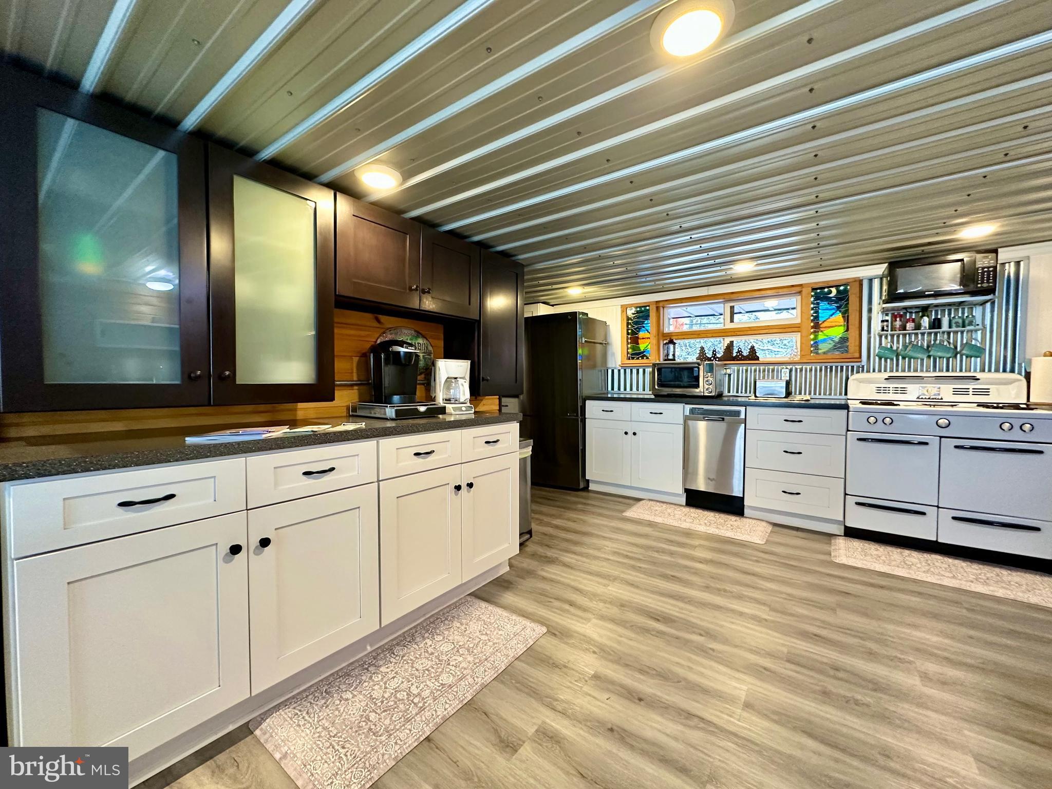 674 Bull Run Road Wrightsville, PA 17368 - Photo 11 of 62 a large white kitchen with stainless steel appliances granite countertop a stove and cabinets