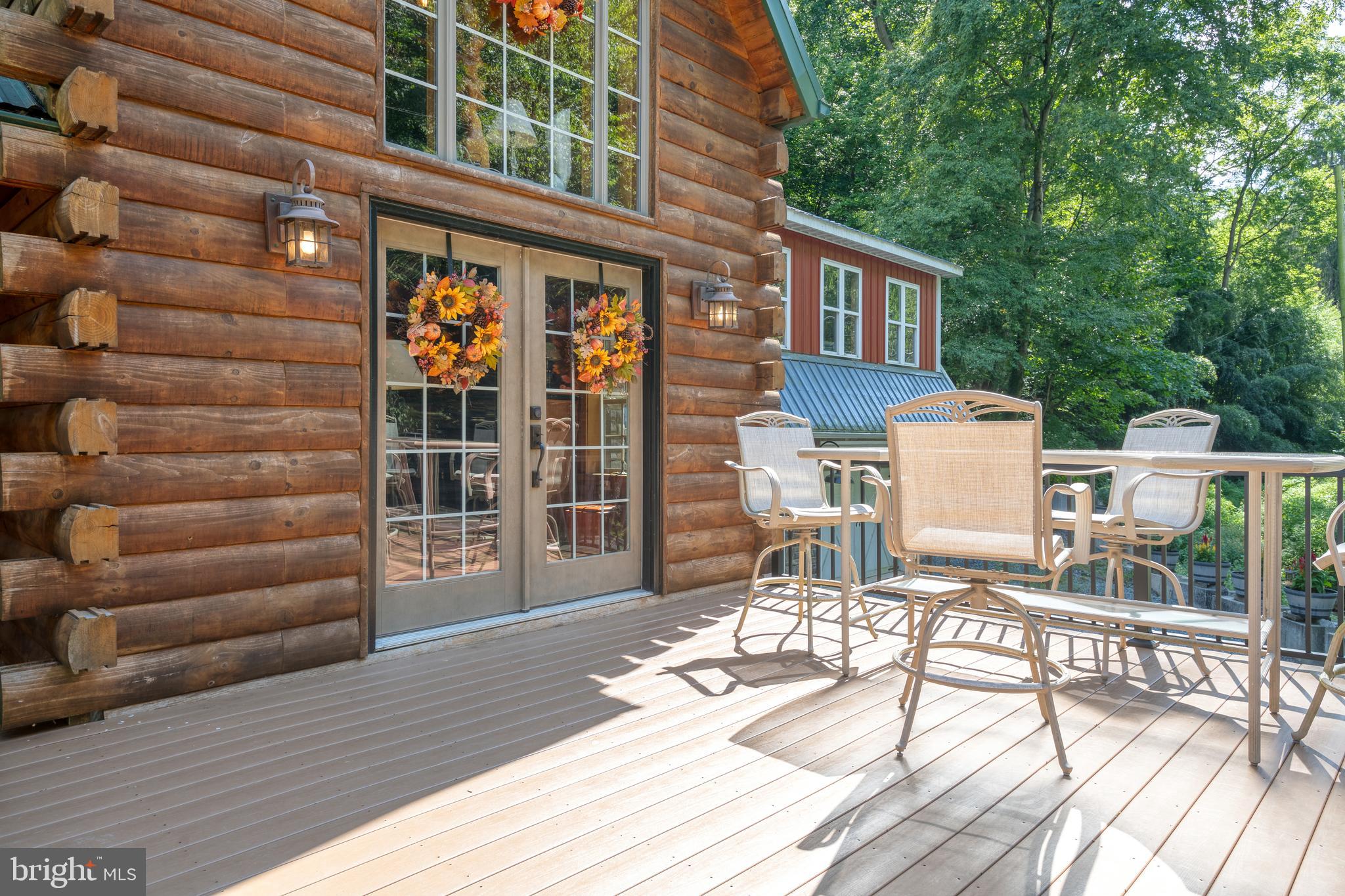 674 Bull Run Road Wrightsville, PA 17368 - Photo 44 of 62 a view of a patio with a table and chairs and wooden floor