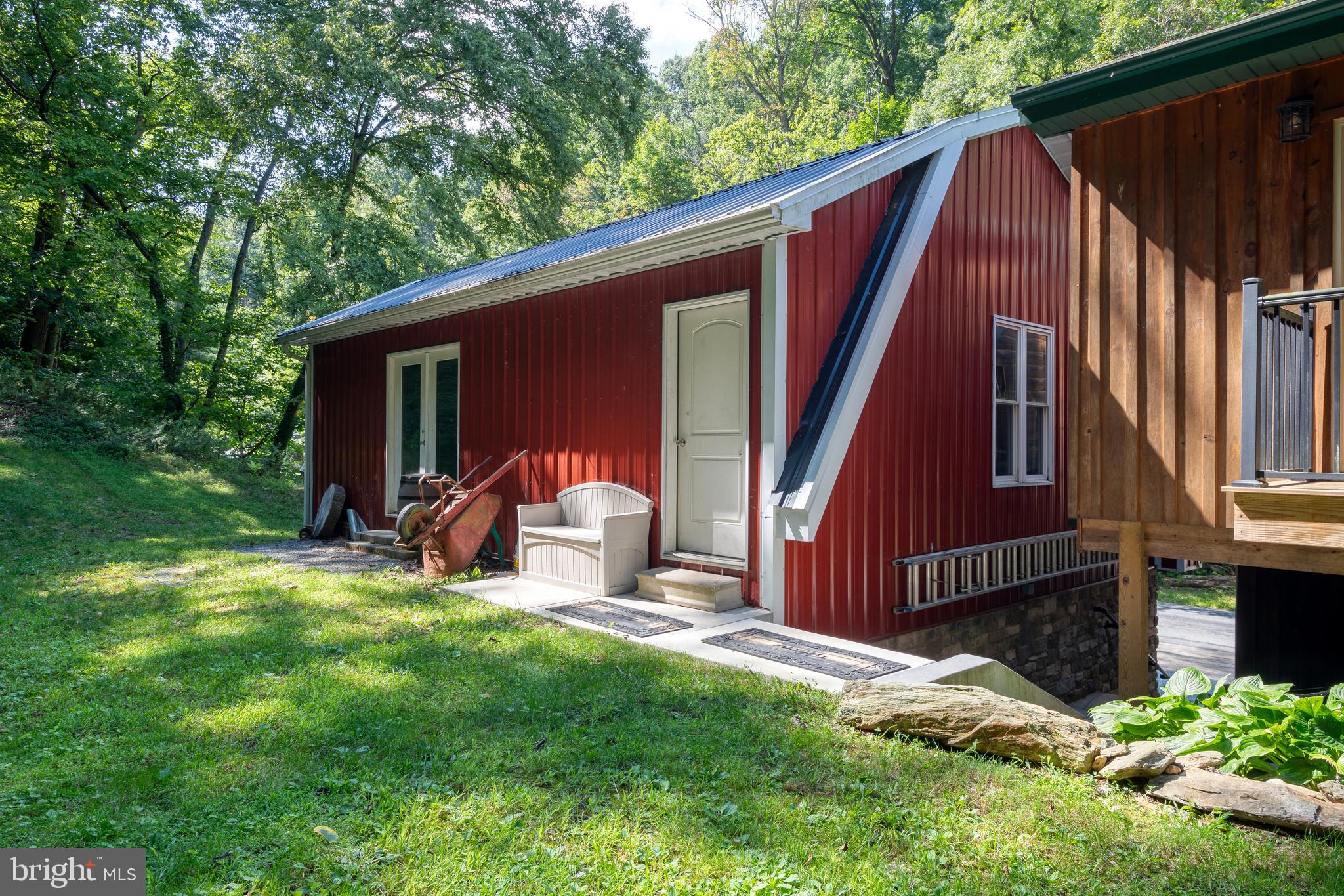 674 Bull Run Road Wrightsville, PA 17368 - Photo 54 of 62 a backyard of a house with table and chairs a barbeque and wooden fence