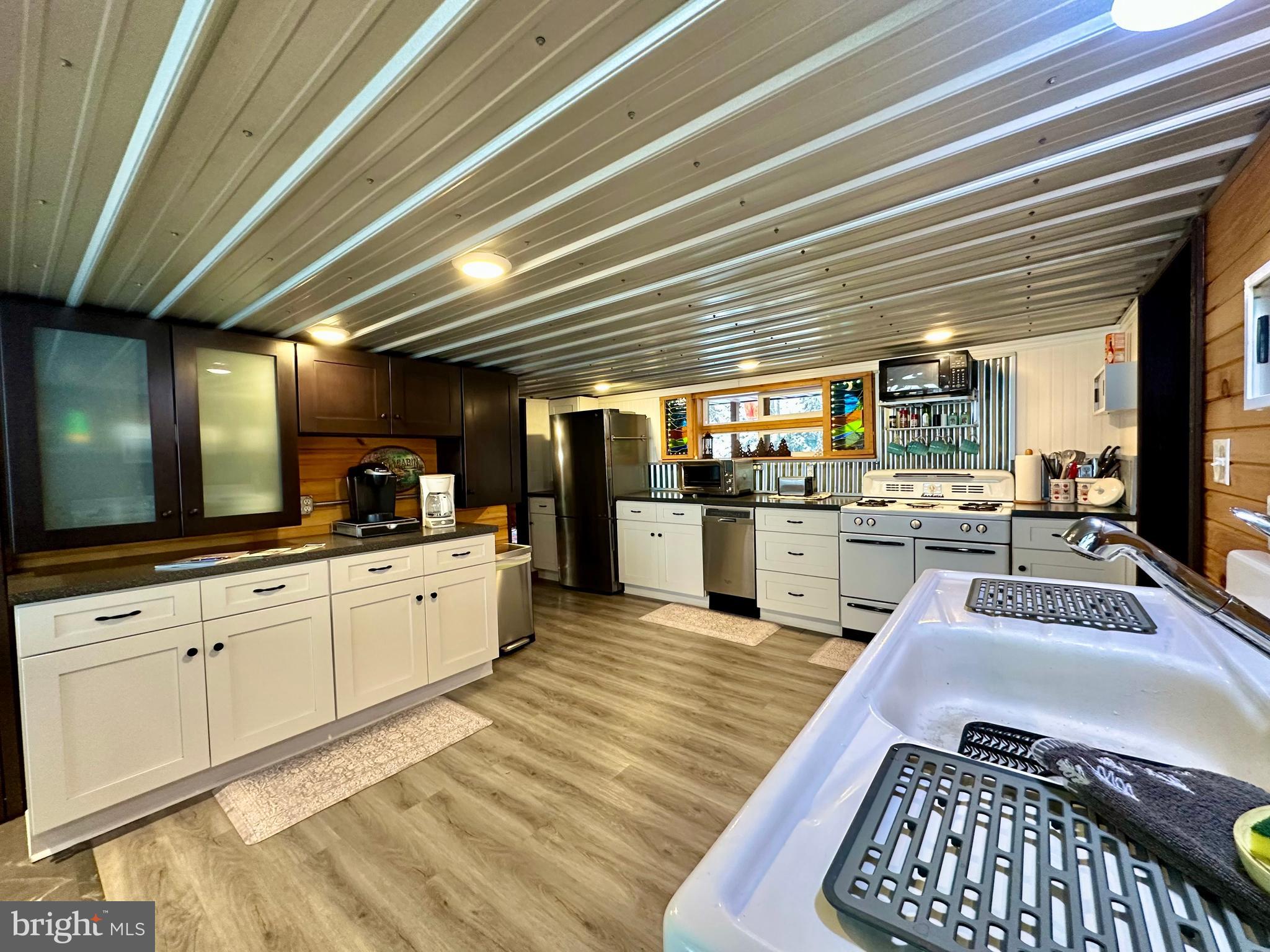 674 Bull Run Road Wrightsville, PA 17368 - Photo 8 of 62 a kitchen with stainless steel appliances granite countertop a sink window and cabinets