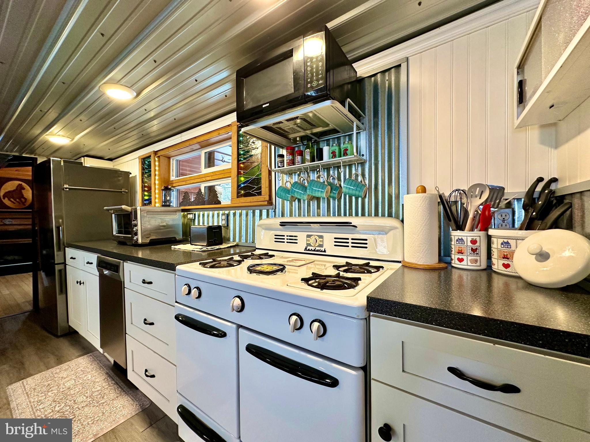 674 Bull Run Road Wrightsville, PA 17368 - Photo 10 of 62 a kitchen with stainless steel appliances granite countertop a stove and a sink