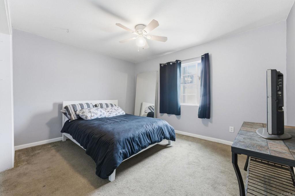 10019 Tamil Road Lakeside, CA 92040 - Photo 12 of 22 a spacious bedroom with a bed and a chandelier