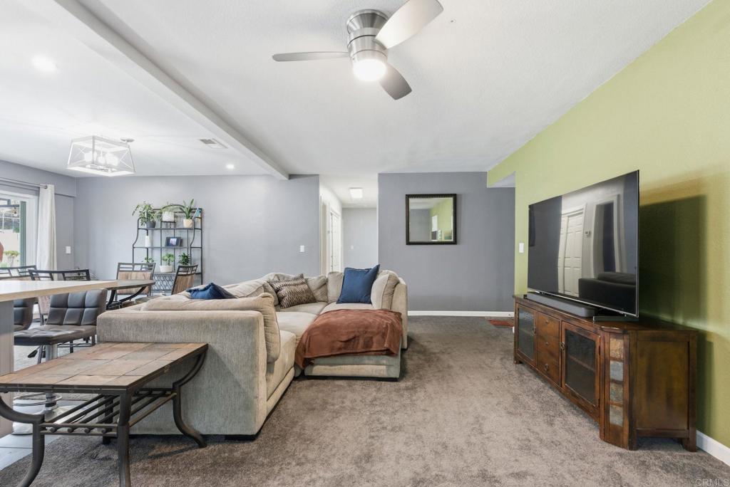 10019 Tamil Road Lakeside, CA 92040 - Photo 7 of 22 a living room with furniture a flat screen tv and kitchen view