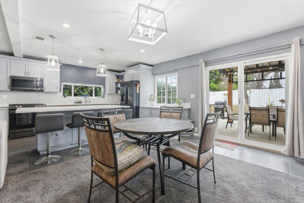 10019 Tamil Road Lakeside, CA 92040 - Photo 9 of 22 a dining room with stainless steel appliances kitchen island granite countertop a dining table and chairs