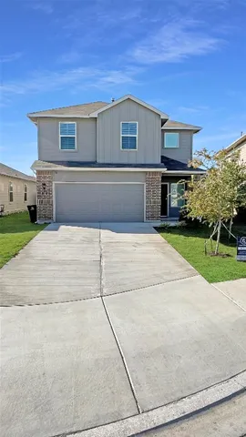 a front view of house with yard and trees