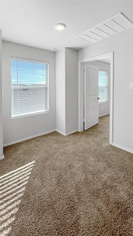 an empty room with a window and closet