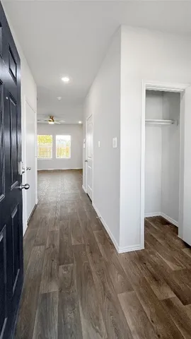 a view of a hallway with wooden floor