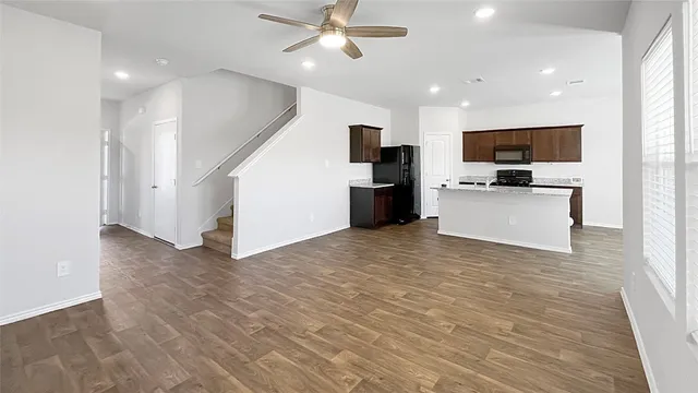 a view of a kitchen with a sink and a refrigerator