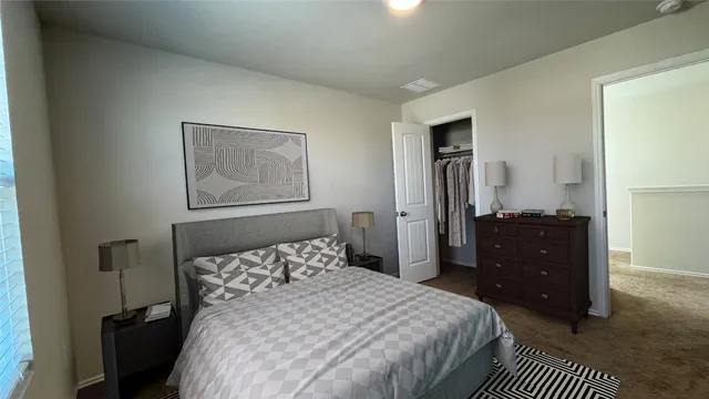a bedroom with a bed and a dresser