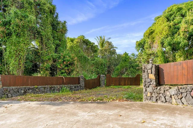 a view of a backyard with wooden fence