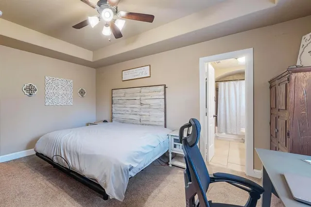 a bedroom with a bed and large windows