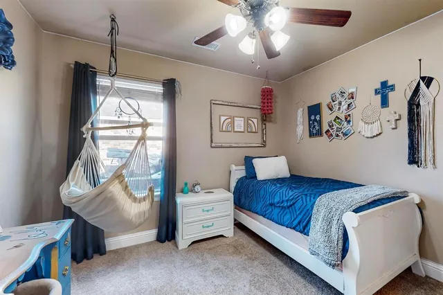 a bedroom with a bed and a flat tv screen on the wall