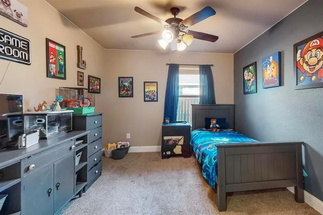 a bedroom with bed and a chandelier