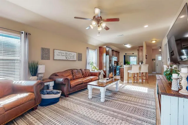 a living room with furniture a chandelier and a rug