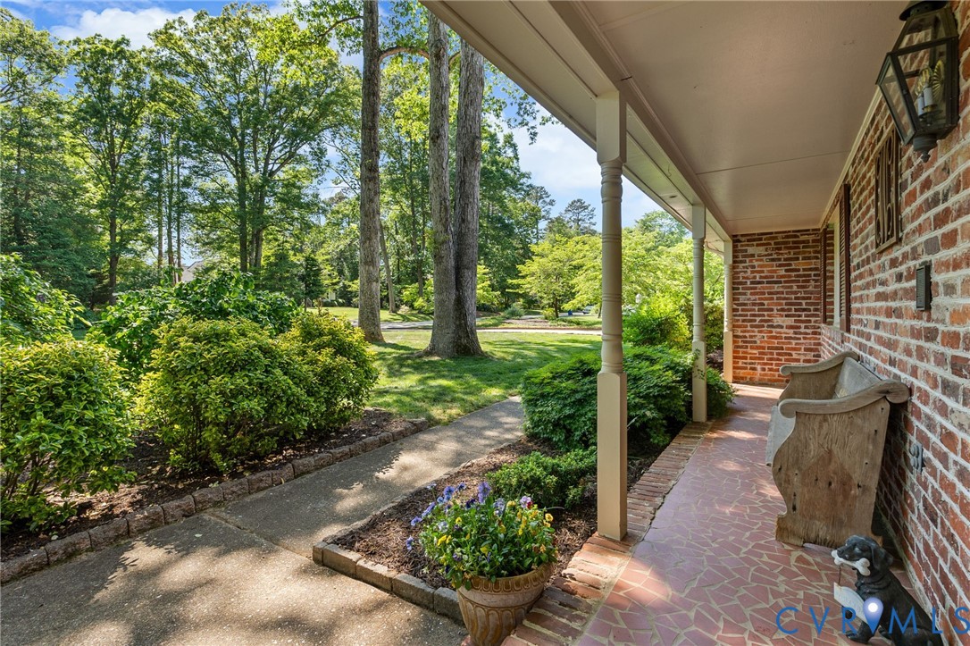 5700 Elfinwood Road Chester, VA 23831 - Photo 5 of 38 a view of a garden with potted plants and large trees