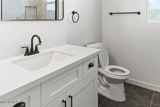 a view of an empty room with closet and mirror