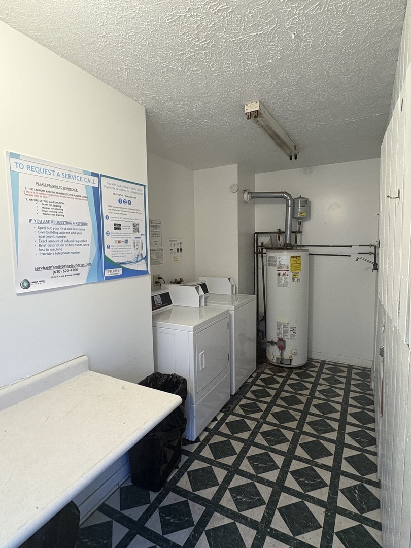 1119 South Curtis Avenue, Unit A1 Kankakee, IL 60901 - Photo 8 of 8 a room with a washing machine and a refrigerator