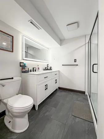 a white toilet sitting next to a bathroom sink