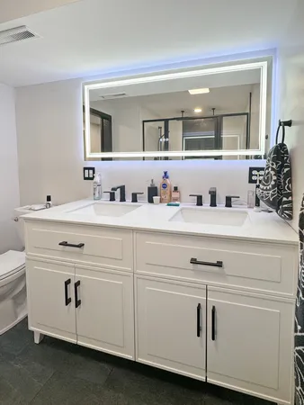 a bathroom with a sink vanity and mirror