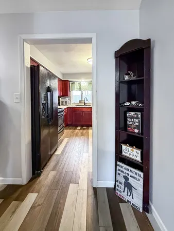 a view of a hallway view with wooden floor and furniture