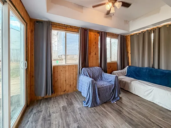 a living room with a couch and a large window with wooden floor