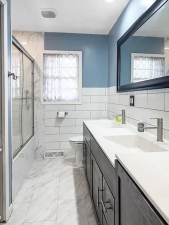 a bathroom with a sink double vanity and a mirror