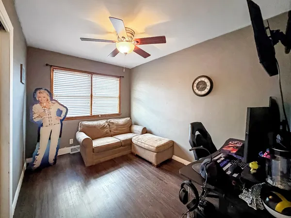 a view of a workspace with furniture and wooden floor