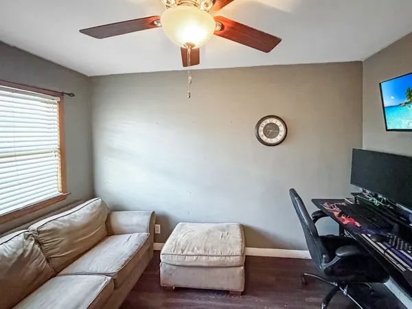 a bedroom with a bed and a wooden floor